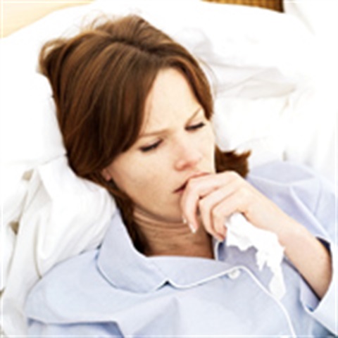 Seasonal Flu Woman sick lying down with tissue